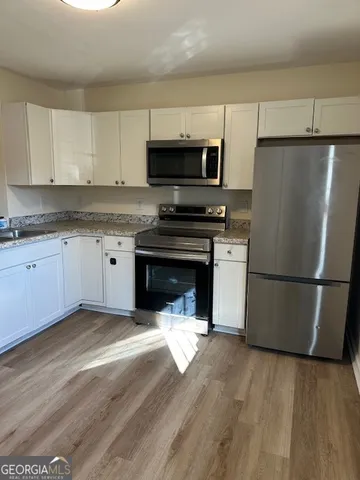 an empty room with a ceiling fan and windows