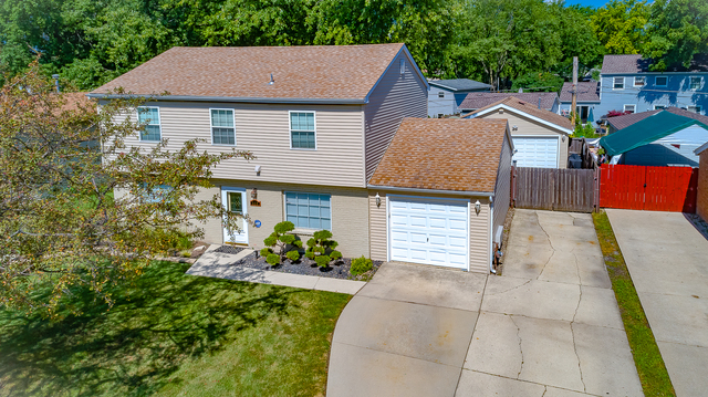 558 Redwood Road Bolingbrook, IL 60440 - Photo 1 of 12 a aerial view of a house with a yard and potted plants