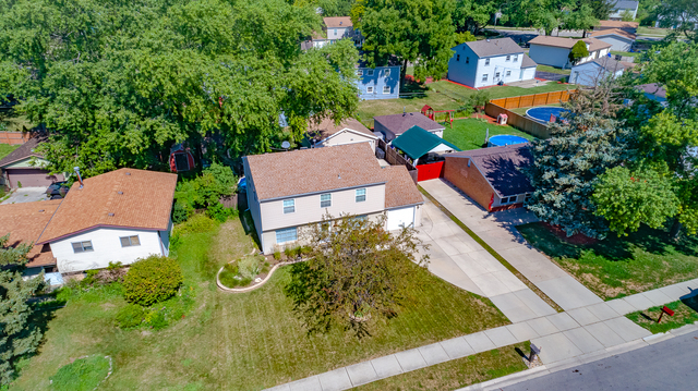 558 Redwood Road Bolingbrook, IL 60440 - Photo 9 of 12 an aerial view of residential houses with outdoor space