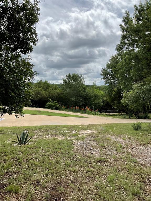 4920 Shining Star Trail Rio Vista, TX 76093 - Photo 39 of 39 a view of yard with swimming pool and trees in the background
