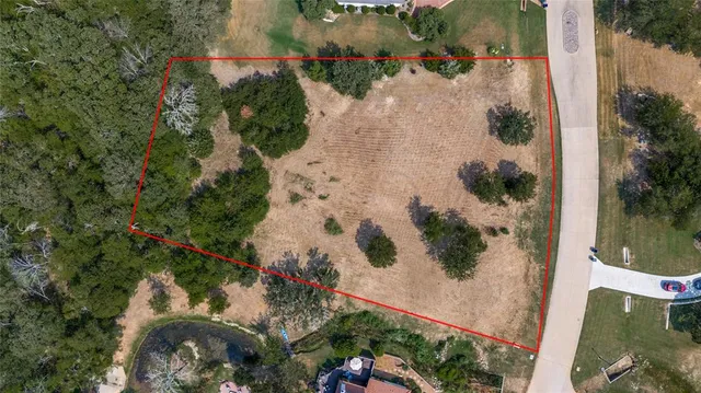 an aerial view of a house with a yard and a fountain