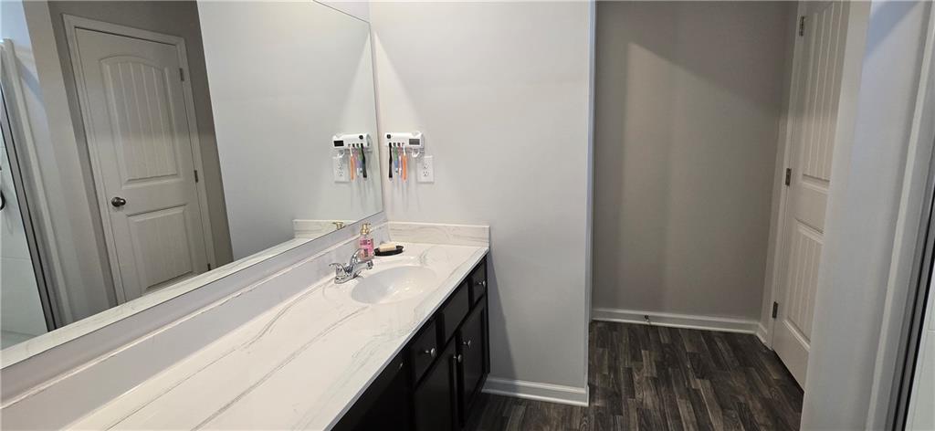 4757 Rdg Vly Drive Gainesville, GA 30504 - Photo 16 of 35 a bathroom with a sink a mirror and vanity