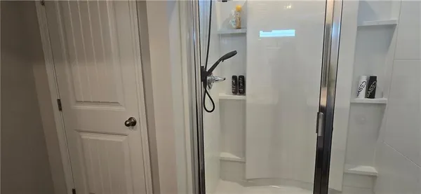 a bathroom with a glass shower door