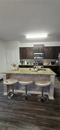 a kitchen with kitchen island granite countertop a sink and counter space
