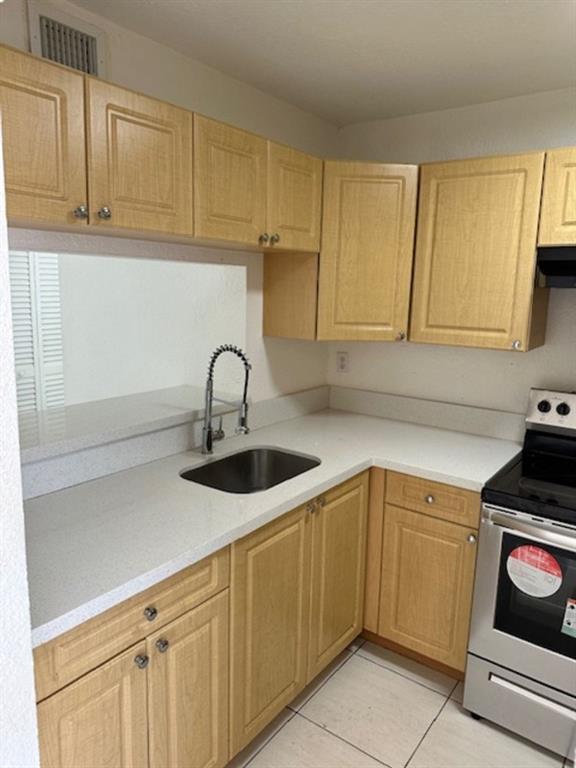 1095 West 77th Street, Unit 210 Hialeah, FL 33014 - Photo 2 of 6 a kitchen with a sink and cabinets