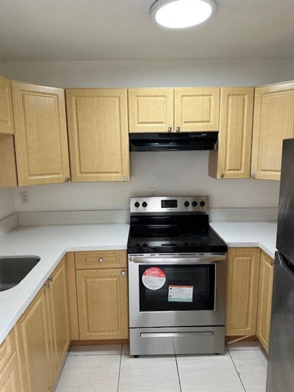 1095 West 77th Street, Unit 210 Hialeah, FL 33014 - Photo 3 of 6 a kitchen with granite countertop a stove top oven microwave and cabinets