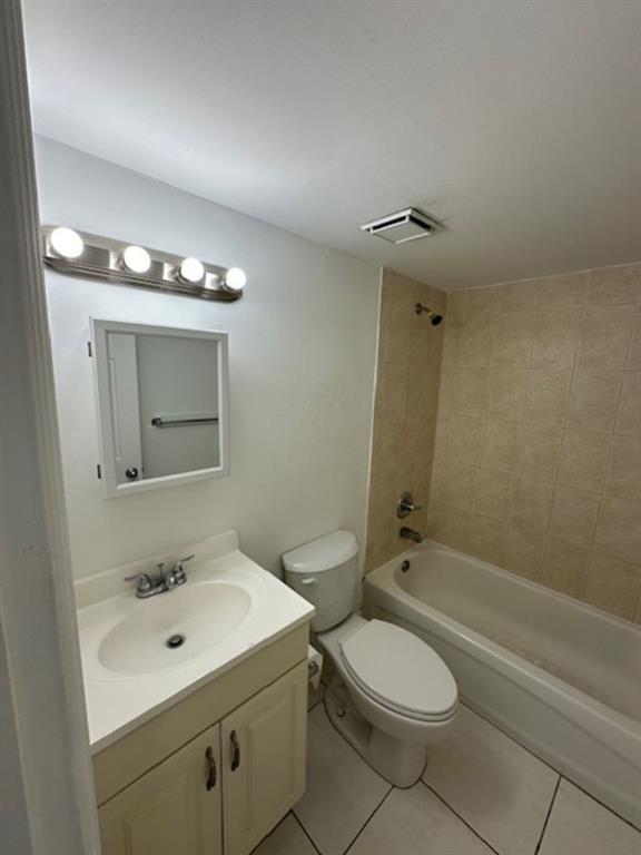 1095 West 77th Street, Unit 210 Hialeah, FL 33014 - Photo 6 of 6 a bathroom with a toilet a sink a mirror and shower