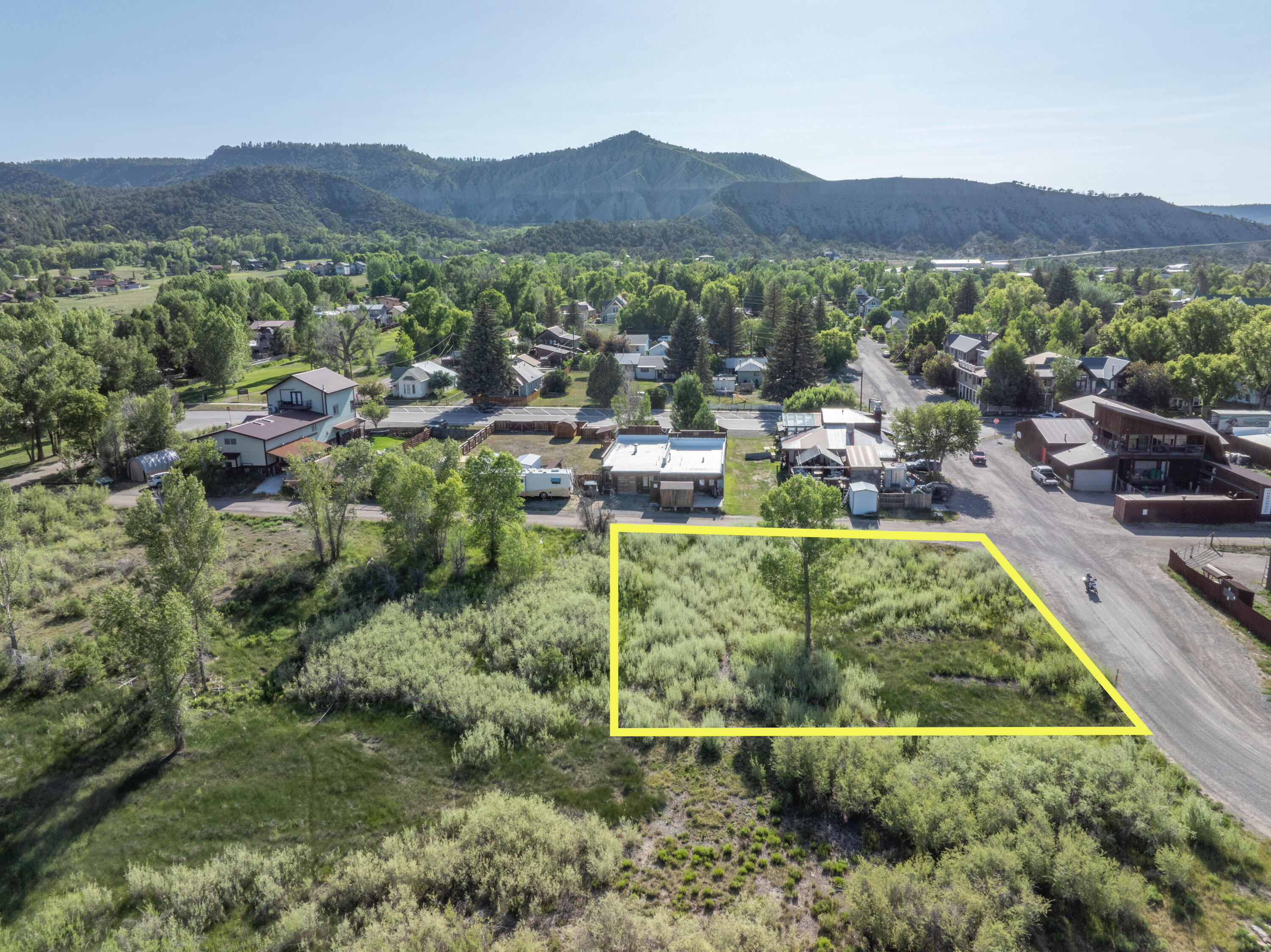 a view of a lush green hillside and houses