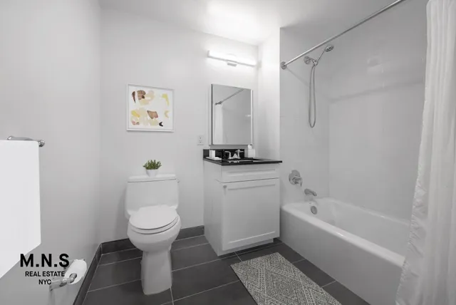a bathroom with a toilet a sink and bathtub
