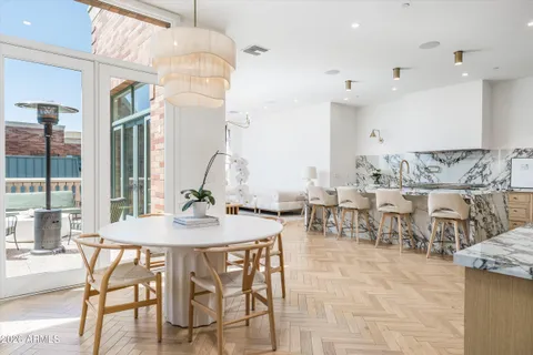 a living room with furniture a chandelier and a window