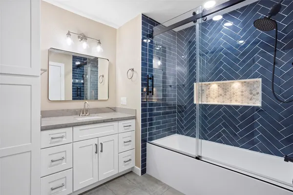 a bathroom with a granite countertop sink a vanity and a mirror