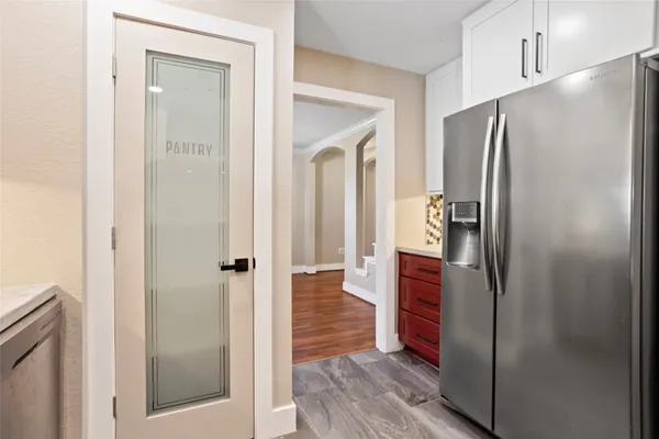 a kitchen with a refrigerator and cabinets
