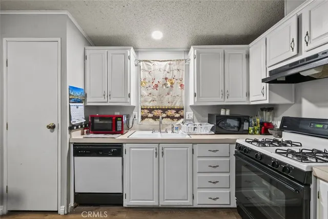 a kitchen with a dining table cabinets appliances and cabinets