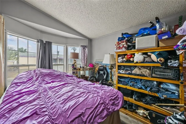 a bed sitting in a bedroom next to a window