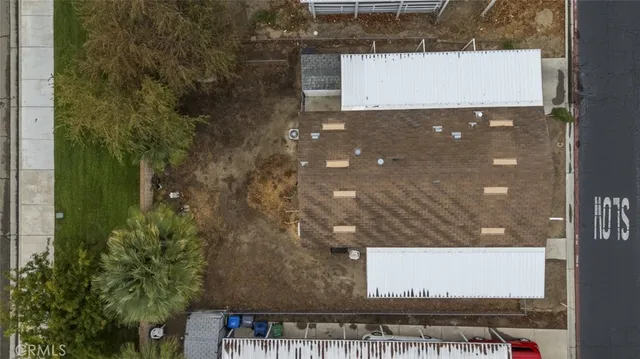 an aerial view of a house with a garden and signage