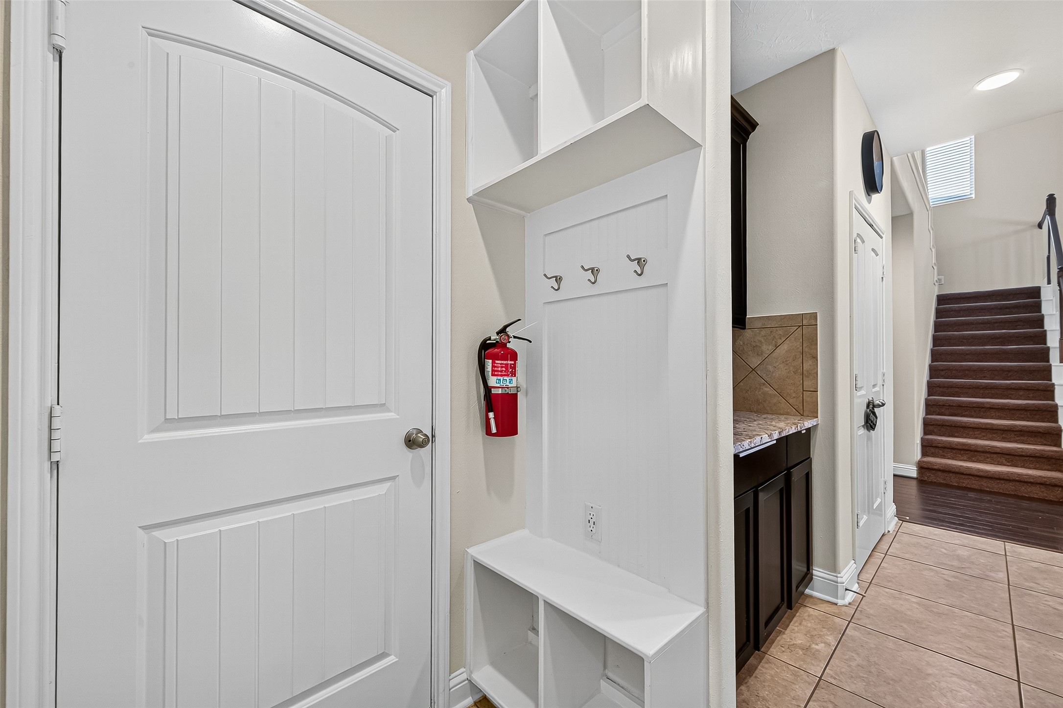 8107 Lockridge Terrace Lane Cypress, TX 77433 - Photo 23 of 50 Step in from the garage to a thoughtfully designed mudroom with built-in bench and hooks—ideal for dropping bags, shoes, and coats. This practical space keeps your home organized while offering a seamless transition into the kitchen and main living areas.