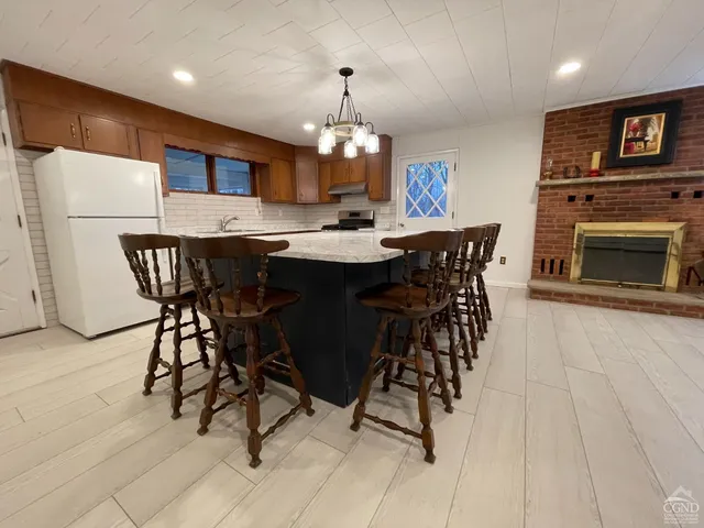 a view of a dining room with furniture and a chandelier