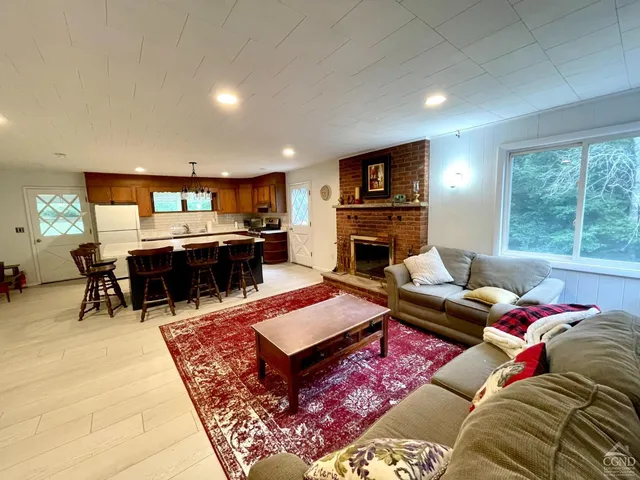 a living room with furniture a rug and a flat screen tv