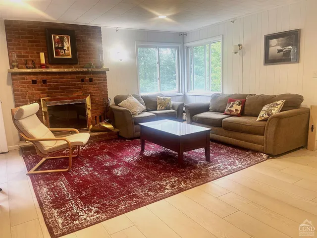 a living room with furniture a rug and a fireplace