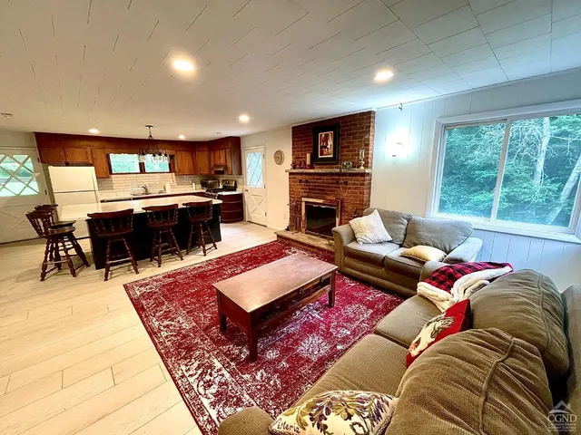 a living room with furniture a rug and a piano