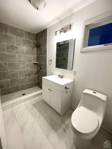 a bathroom with a toilet sink and shower