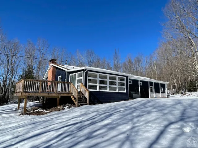 a view of a house with a wooden deck