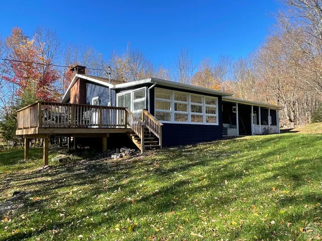 a view of a house with a yard and sitting area