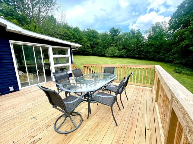 a view of sitting area with furniture and wooden deck