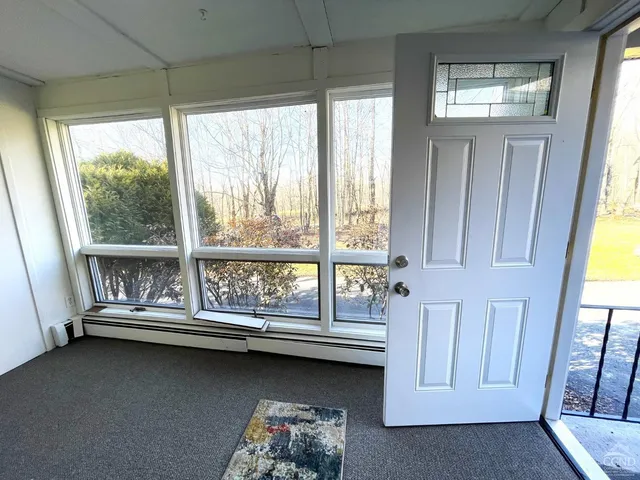 a view of room with window and air conditioner