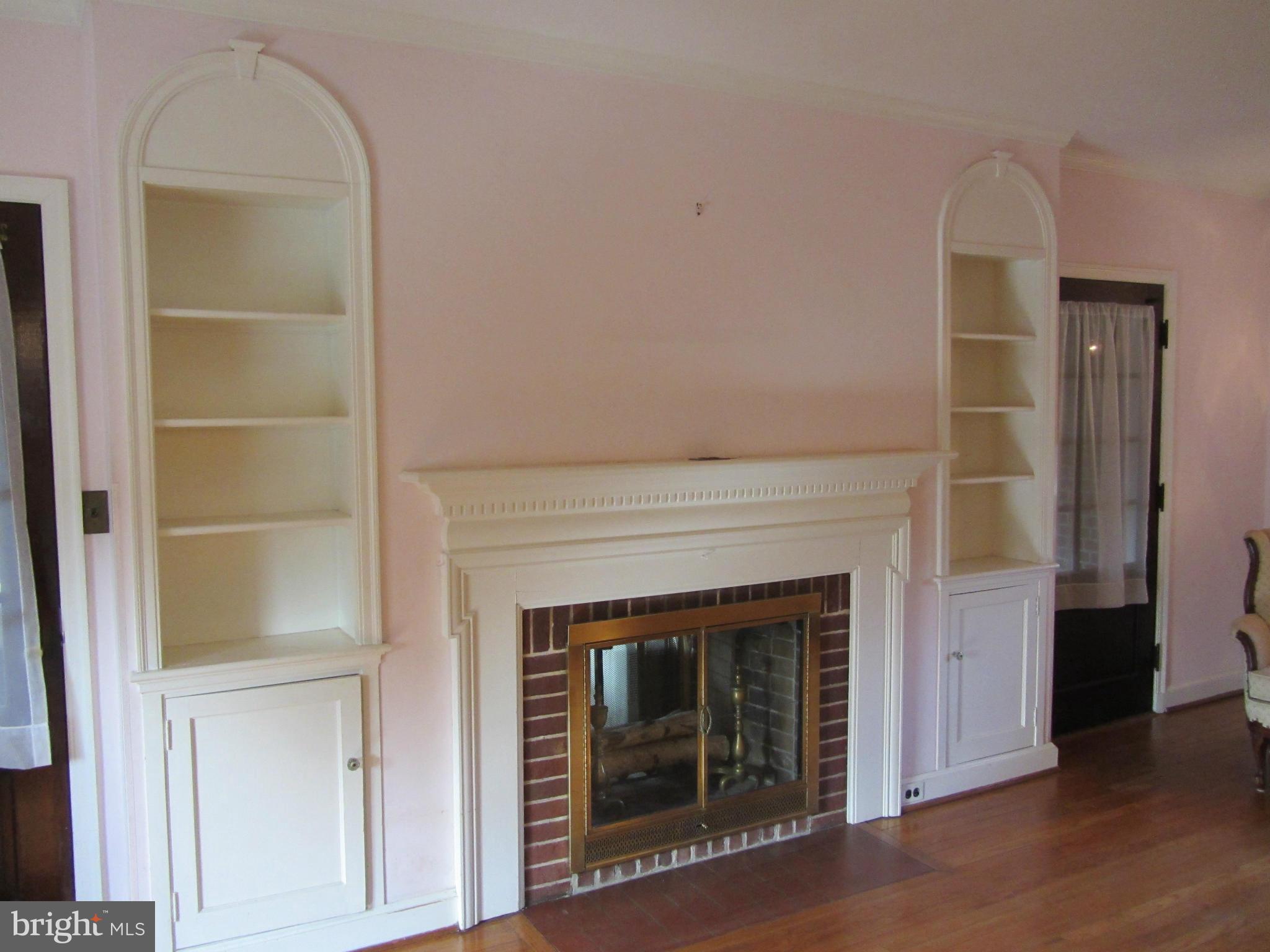 203 Aigburth Road Baltimore, MD 21286 - Photo 6 of 21 Living Room with Fireplace & Built-in Shelving