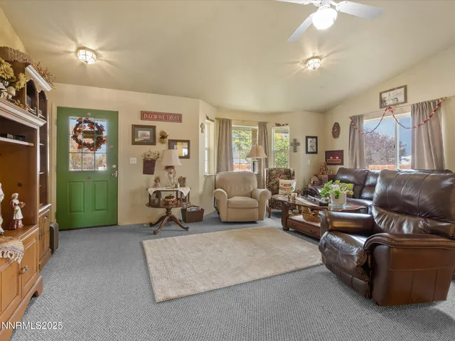 a open kitchen with stainless steel appliances granite countertop a stove top oven a dining table and chairs