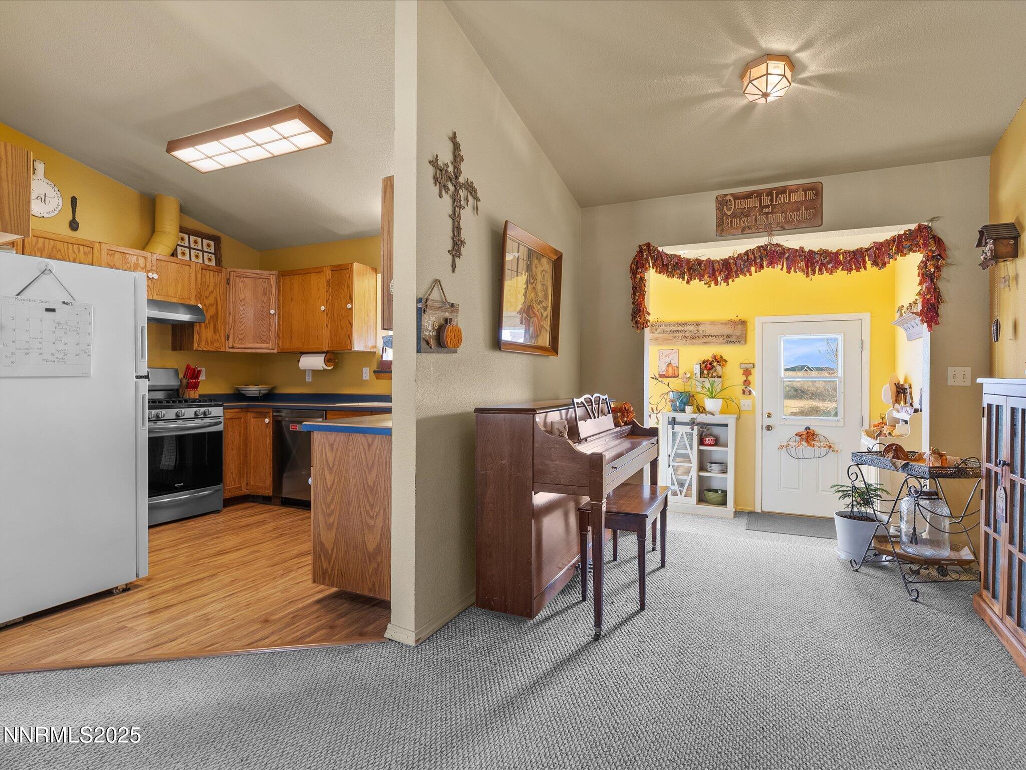 215 Hunter Park Way Fallon, NV 89406 - Photo 14 of 57 a open kitchen with stainless steel appliances granite countertop a stove top oven a dining table and chairs