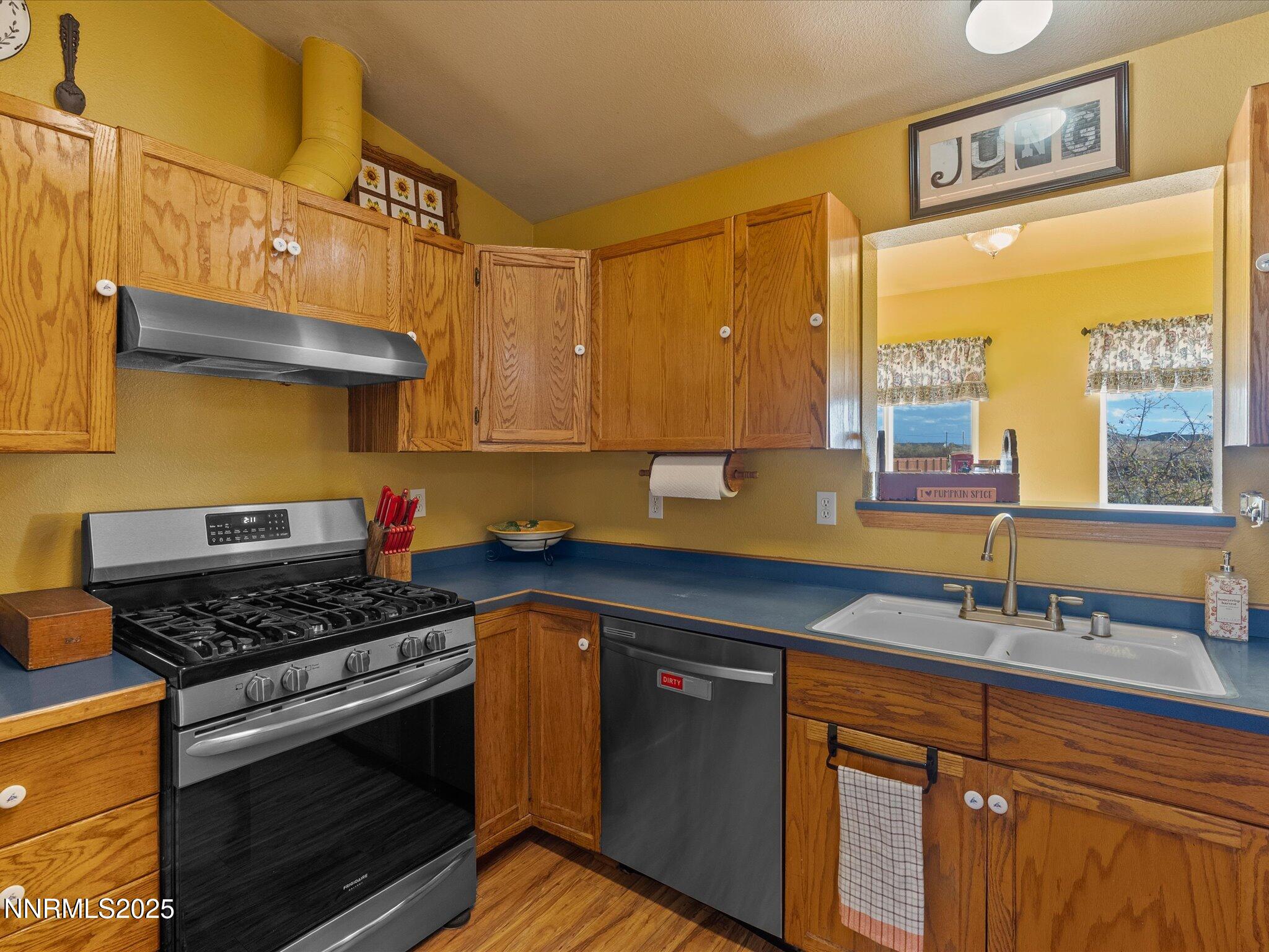 215 Hunter Park Way Fallon, NV 89406 - Photo 17 of 57 a kitchen with stainless steel appliances a stove a sink and a microwave