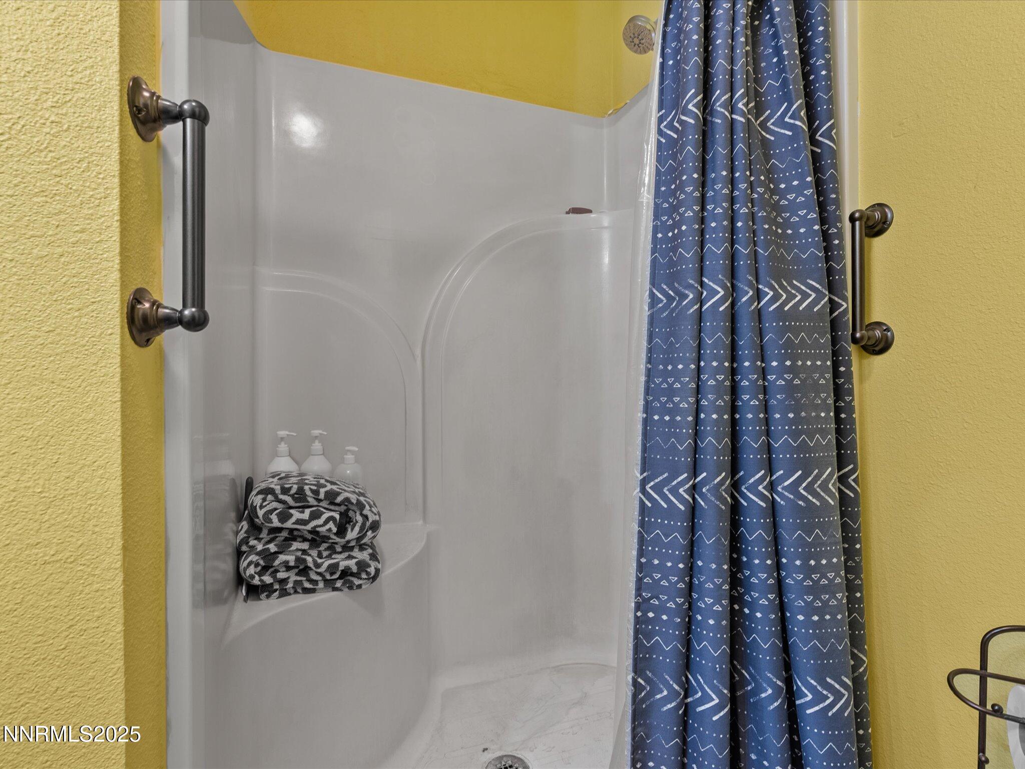 215 Hunter Park Way Fallon, NV 89406 - Photo 22 of 57 a bathroom with a shower curtain and a window