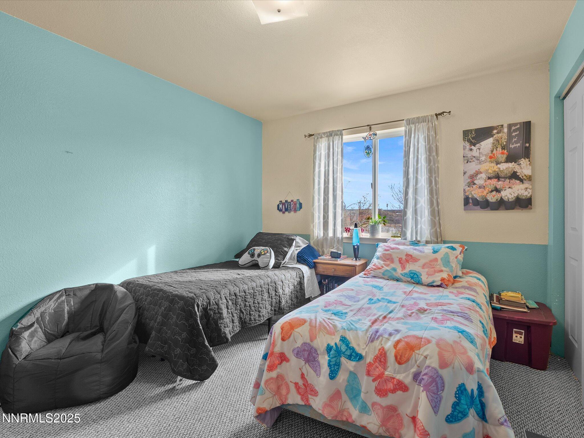 215 Hunter Park Way Fallon, NV 89406 - Photo 25 of 57 a bedroom with two beds and painting on the wall