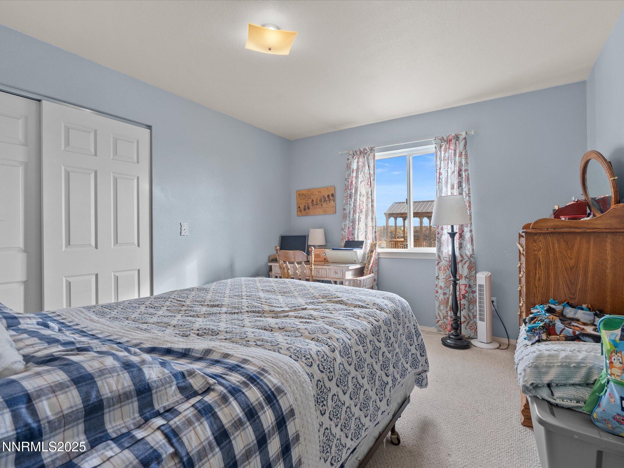 215 Hunter Park Way Fallon, NV 89406 - Photo 27 of 57 a bedroom with bed and window