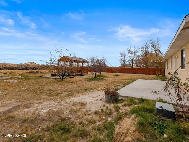 an aerial view of a house with a yard and ocean view