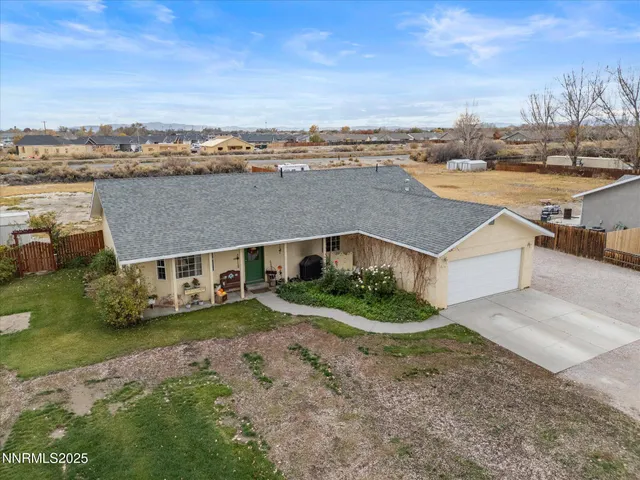 an aerial view of a house with a garden and trees