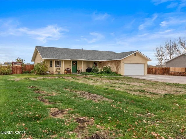 a view of a house with a big yard and potted plants