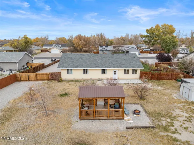 an aerial view of a house with a garden and lake view