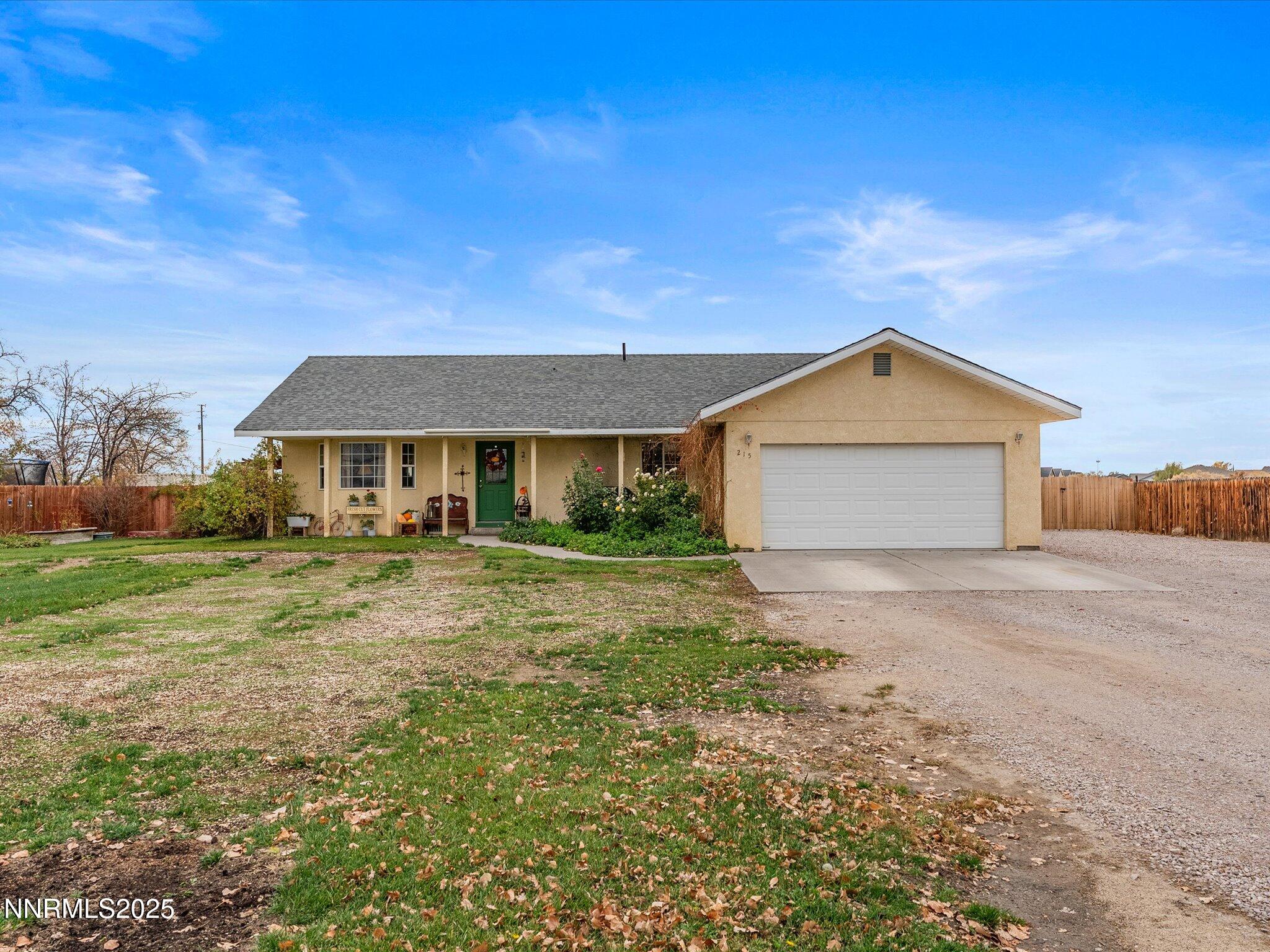 215 Hunter Park Way Fallon, NV 89406 - Photo 7 of 57 a front view of a house with a yard and garage