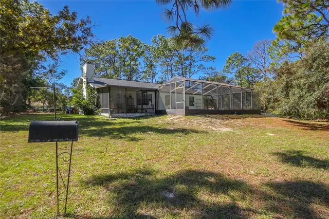 a swimming pool with outdoor seating and yard