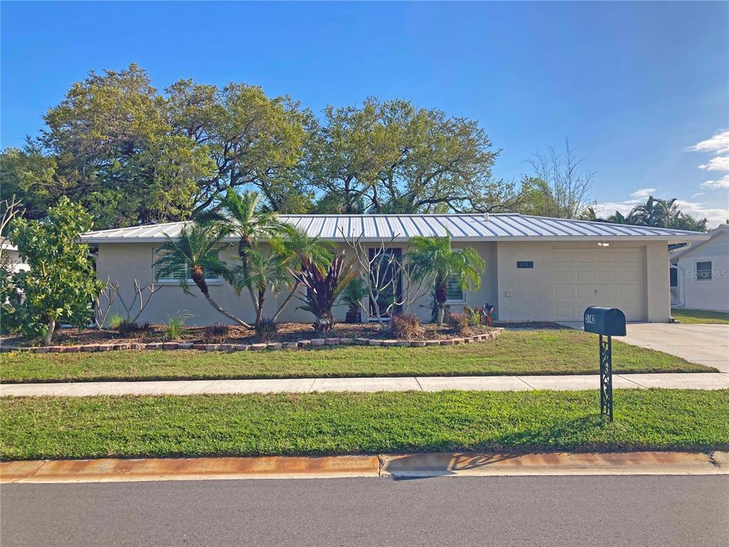 3142 Post Road Sarasota, FL 34231 - Photo 1 of 1 a view of a house with a yard and plants