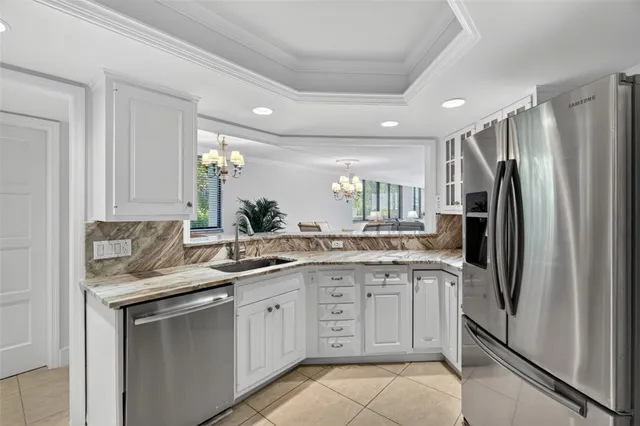 a kitchen with stainless steel appliances granite countertop a stove sink and cabinets