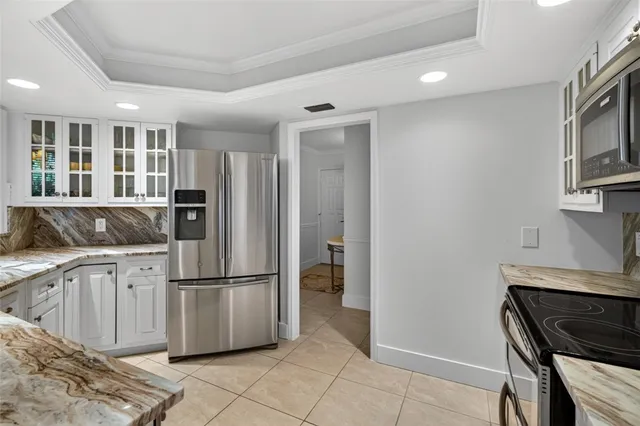 a kitchen with a sink and a large mirror