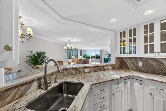 a view of a dining room with furniture a chandelier and wooden floor