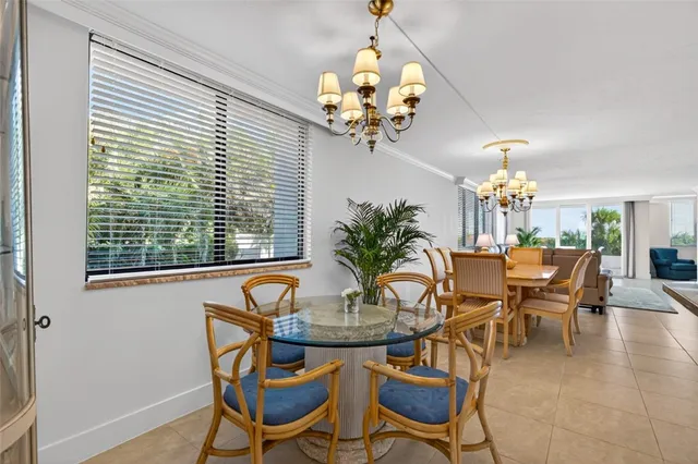 a dining room with furniture and chandelier