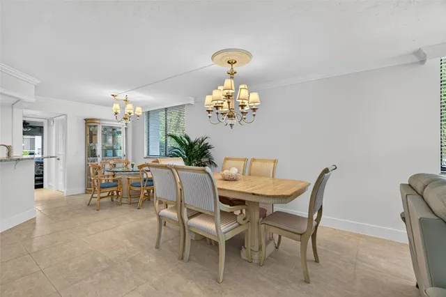a view of a dining room with furniture a chandelier and wooden floor