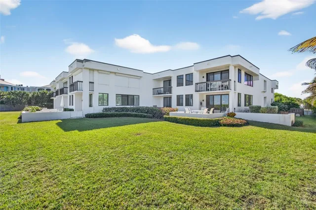 a front view of house with yard and swimming pool
