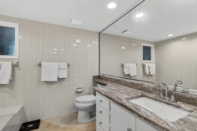 a bathroom with a sink vanity granite and a mirror